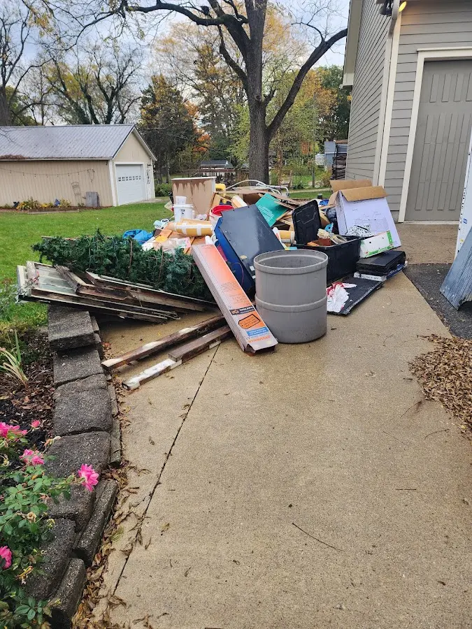 Dumpster being loaded with debris for Estate Cleanout Dumpster Rental in Groves